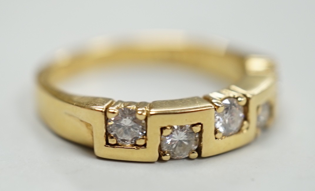 A modern 18ct gold and five stone diamond set half hoop ring, size M/N, gross weight 4.9 grams.